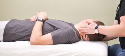 physical therapist doing neck stretches on a patient